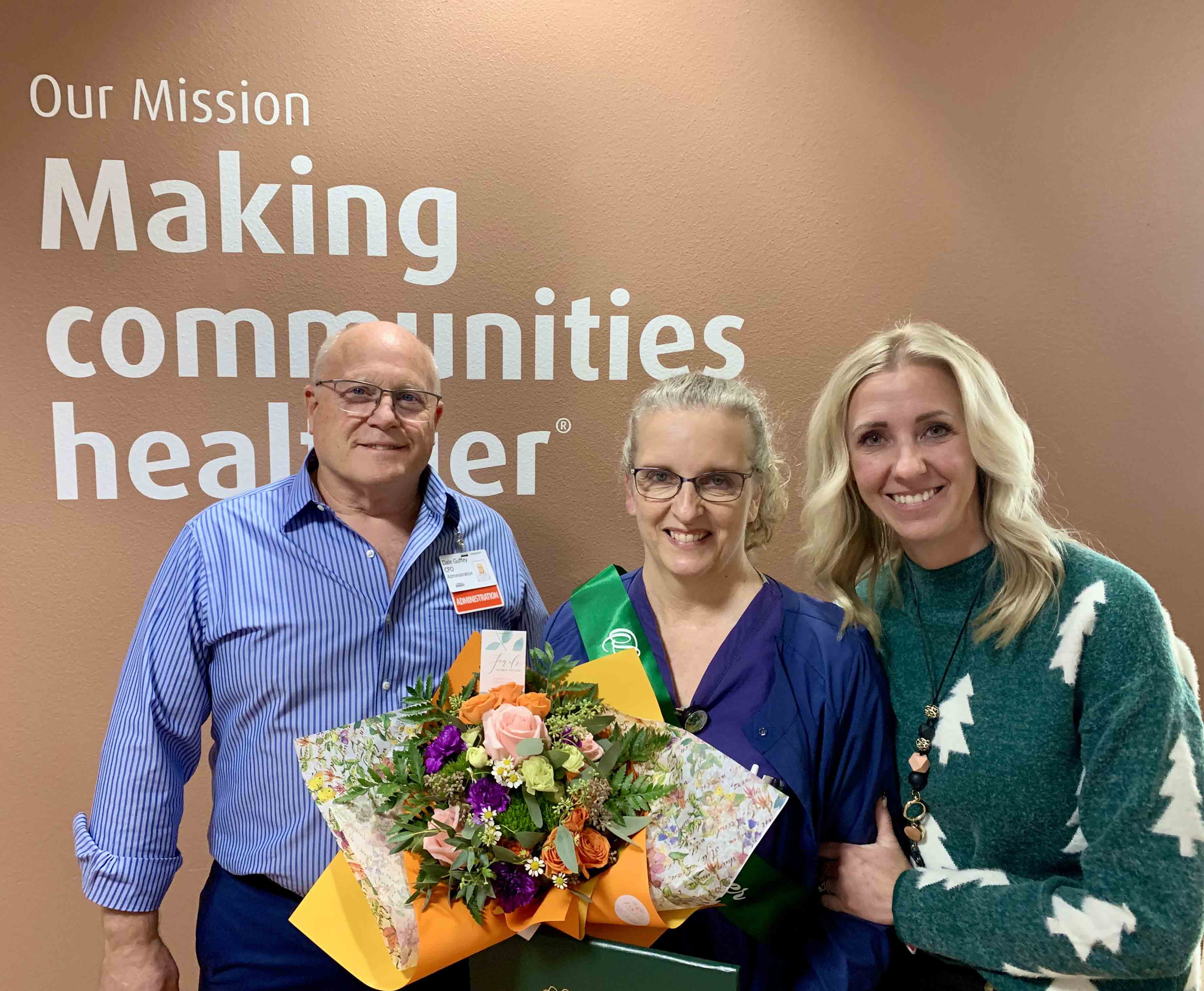 Robin Main poses with CFO Dale Guffey and CNO Becky Jones