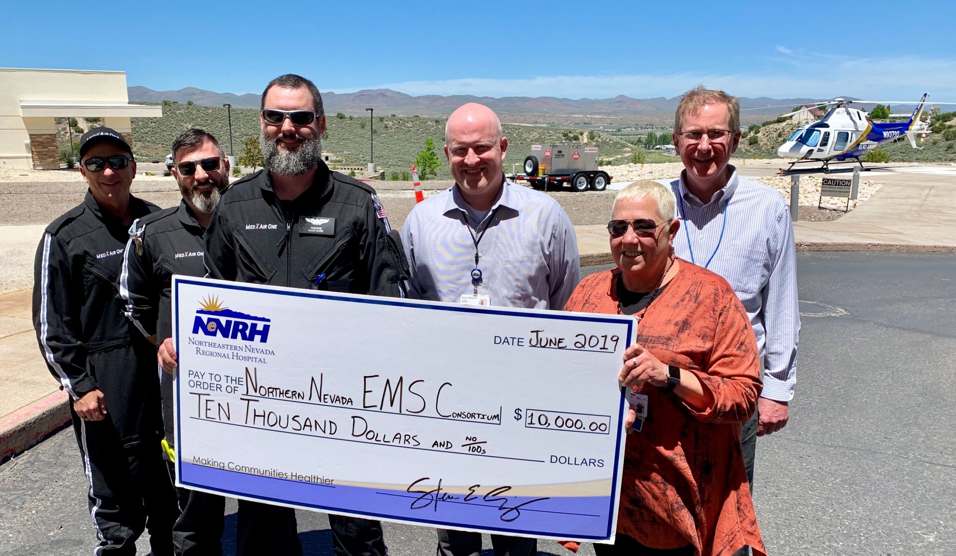 Pictured from left: Dave Low, Mike Fields and Trae Bane, members of the MedX AirOne flight crew; Steve Simpson, NNRH CEO; Alice Allen, NNEMSC Chair; and Greg Hexem, NNRH CFO.