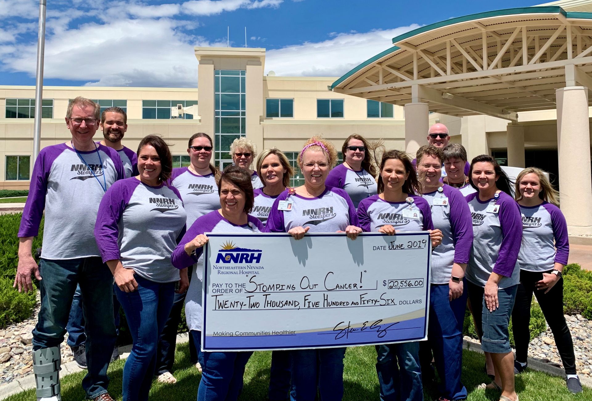 Members of the NNRH Stompers, the hospital’s employee-led Relay For Life team, celebrate the record-breaking amount they raised this year to combat cancer.