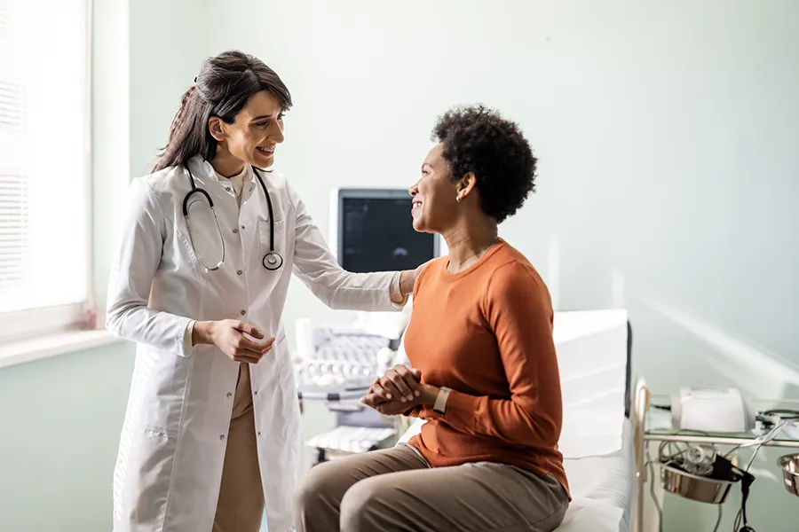 Physician providing care and consultation to a patient during a routine clinic visit